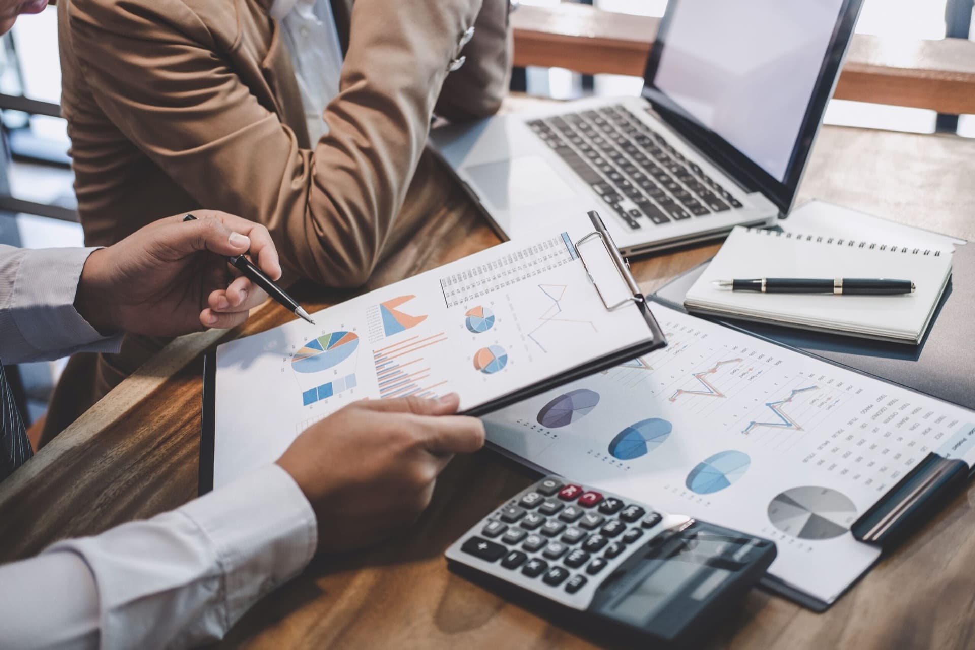 Advisors reviewing financial reports with a client